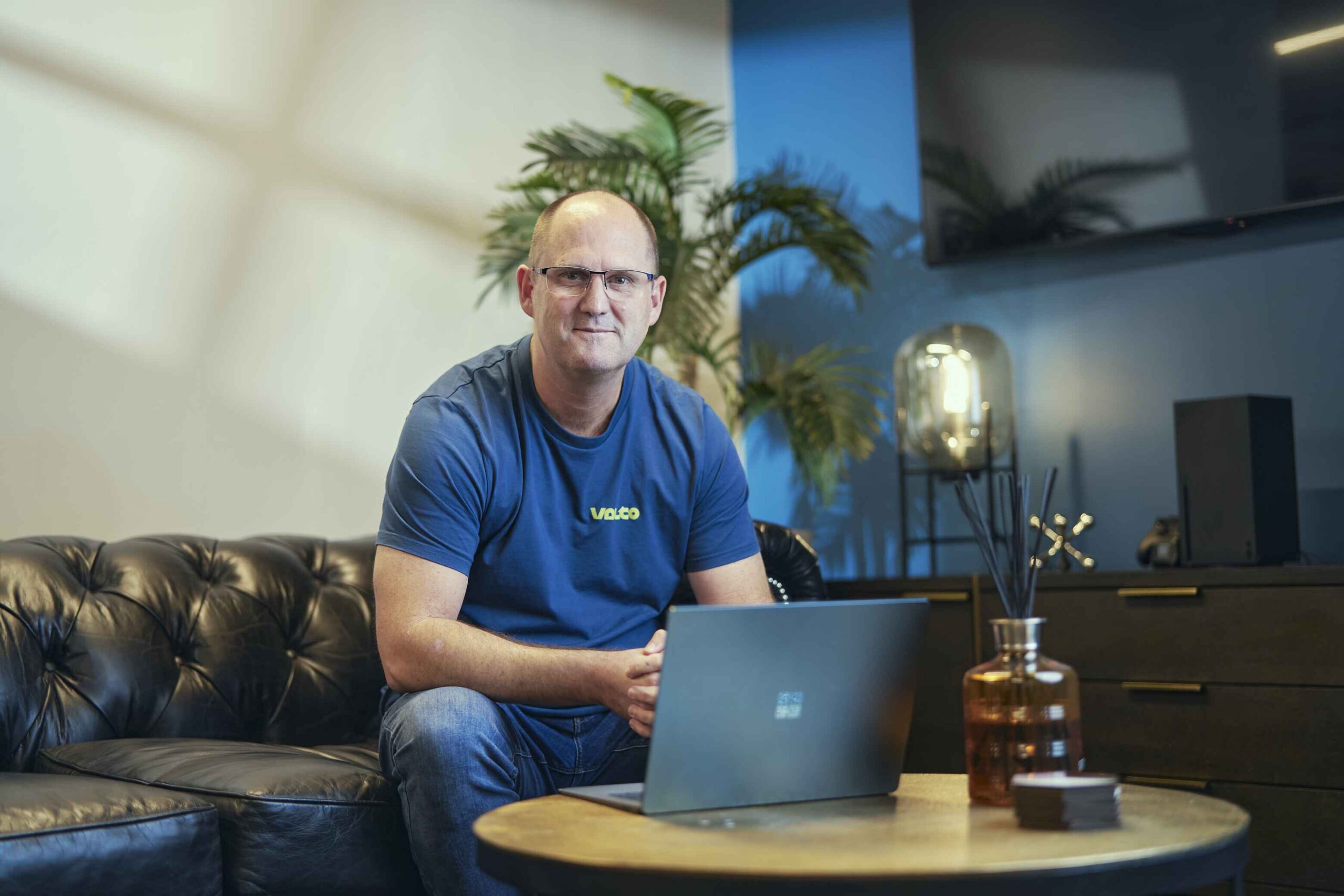 Man sitting on a sofa with a laptop